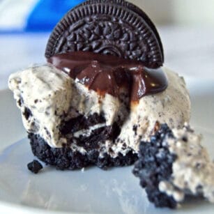 Mini Oreo Cheesecake topped with chocolate ganache and half Oreo cookie.