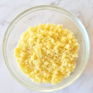 a large mixing bowl contains streusel topping over muffins, cakes, pies.