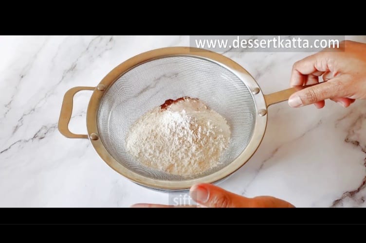 sifting dry ingredients to make banana oatmeal chocolate chip muffin
