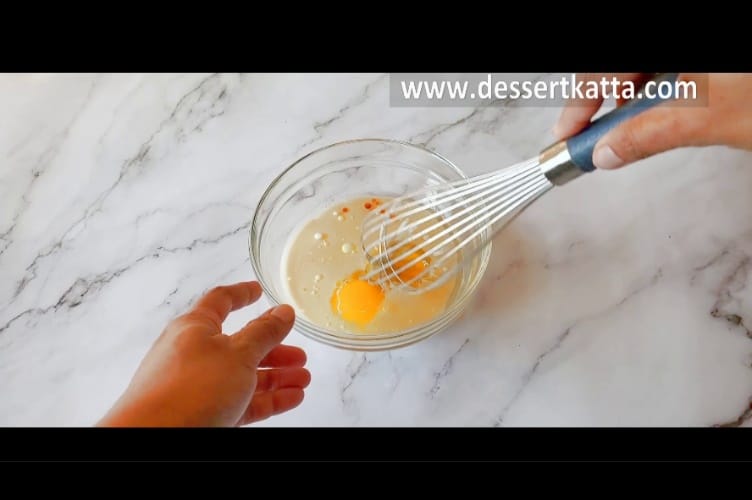 whisking eggs and all wet ingredients with whisk in small glass bowl