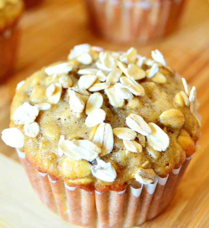 just baked banana oatmeal chocolate chip muffins topped with rolled oats