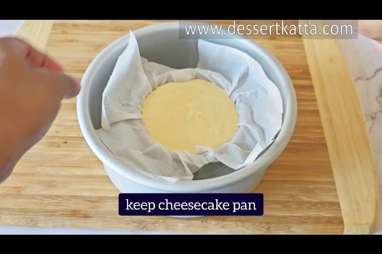 placing cheesecake pan in 7-inch pan with boiling water