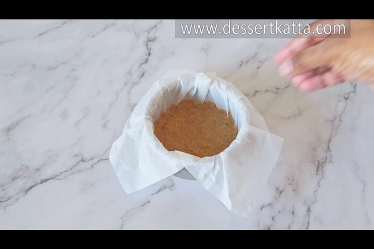 small pan contains base of cheesecake which is ready to be baked