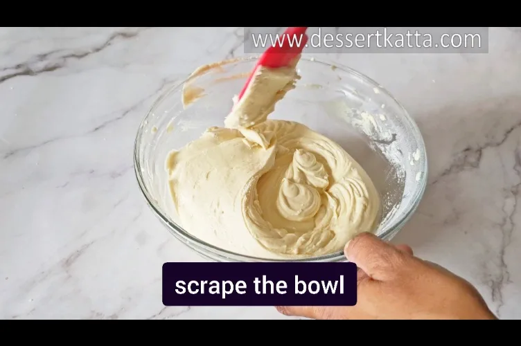 scraping the bowl with red spatula to make Starbucks red velvet loaf recipe