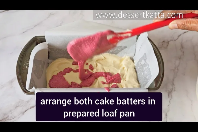 adding red velvet cake batter on top of vanilla cake batter