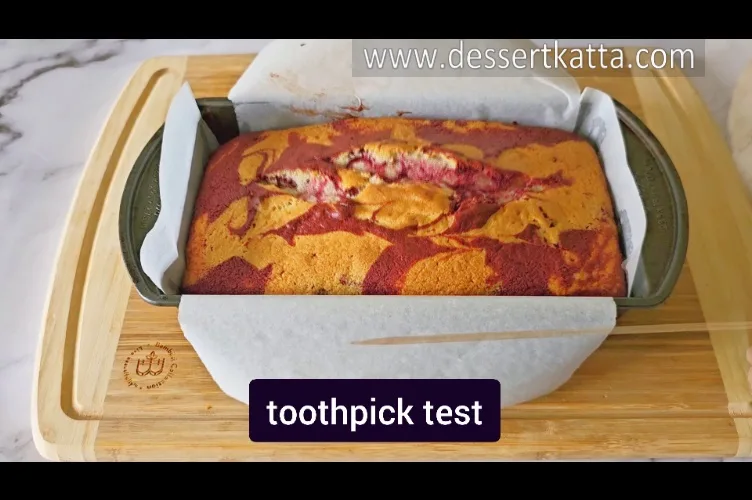 performing toothpick test to check the doneness of Starbucks red velvet loaf cake