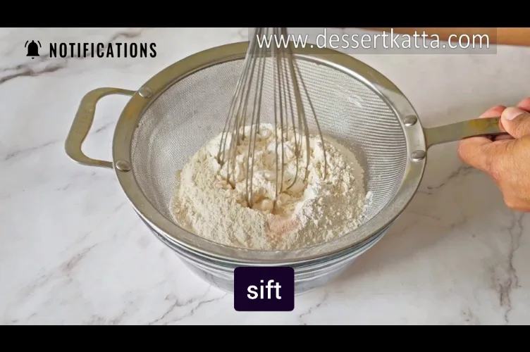 sifting dry ingredients to make Starbucks red velvet loaf cake