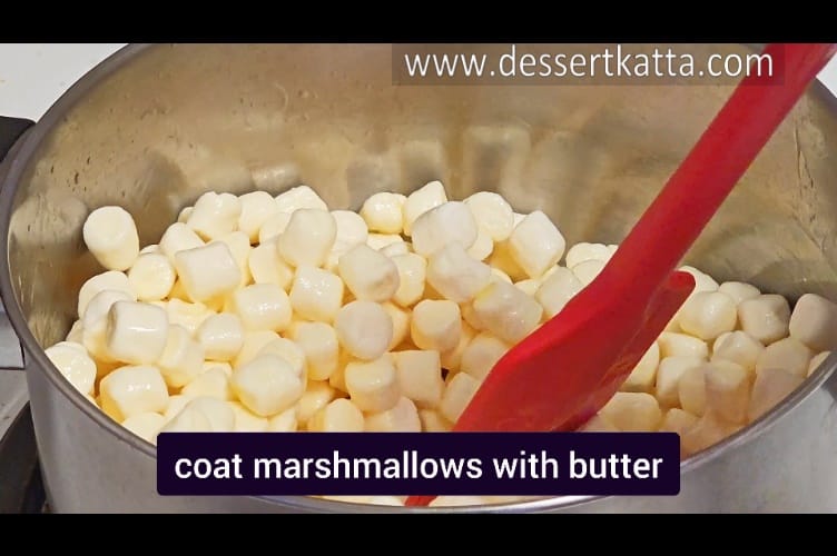 coating marshmallows with melted butter to create Starbucks rice krispy treat recipe