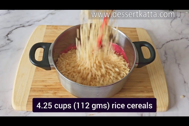 adding 112 grams of crispy rice cereals to melted marshmallows