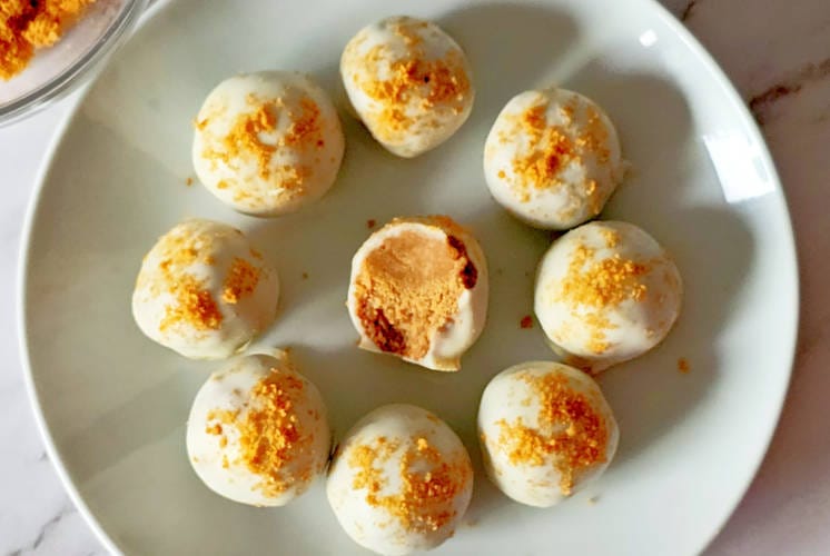 biscoff truffles placed on white plate and showing inside texture