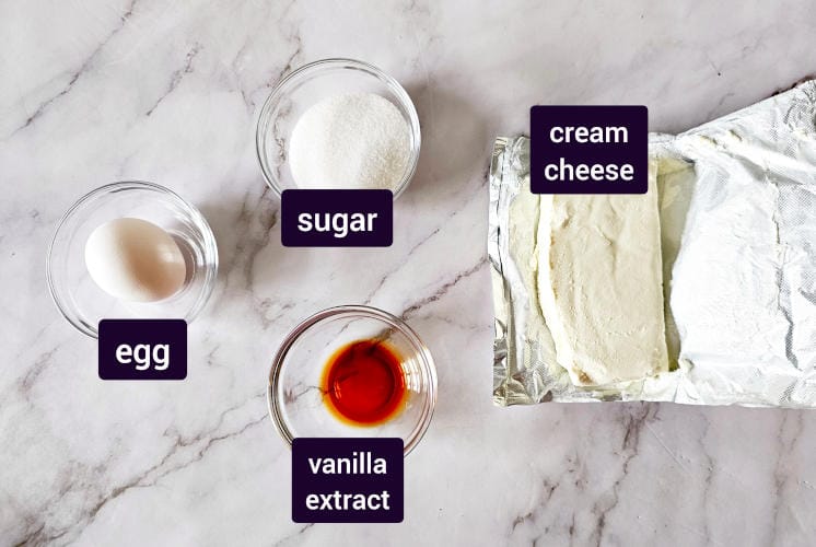 chocolate cheesecake swirl ingredients placed on marble surface