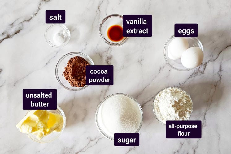 chocolate brownie ingredients placed on marble surface