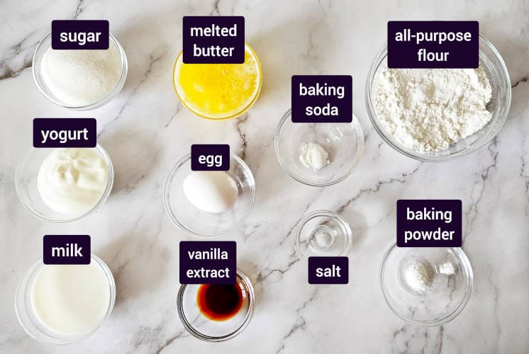Vanilla muffins ingredients placed on marble surface
