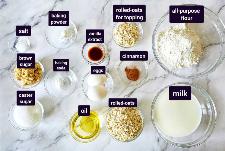 oatmeal muffins ingredients placed on marble background in small bowls