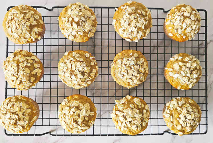 top shot of 12 oatmeal muffins placed on a wire rack
