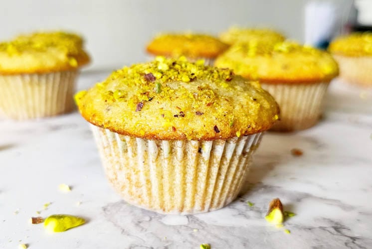 front shot of pistachio muffins showing the dome shaped top