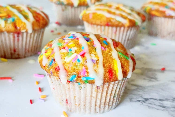 front shot of funfetti muffins with few in the background