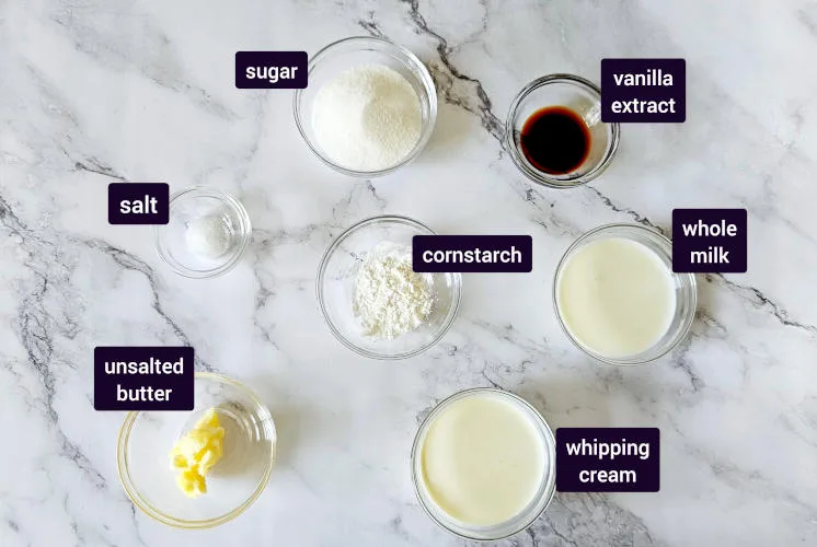 ingredients for vanilla sauce recipe are placed on marble background in small bowls to prepare chocolate Nutella cake